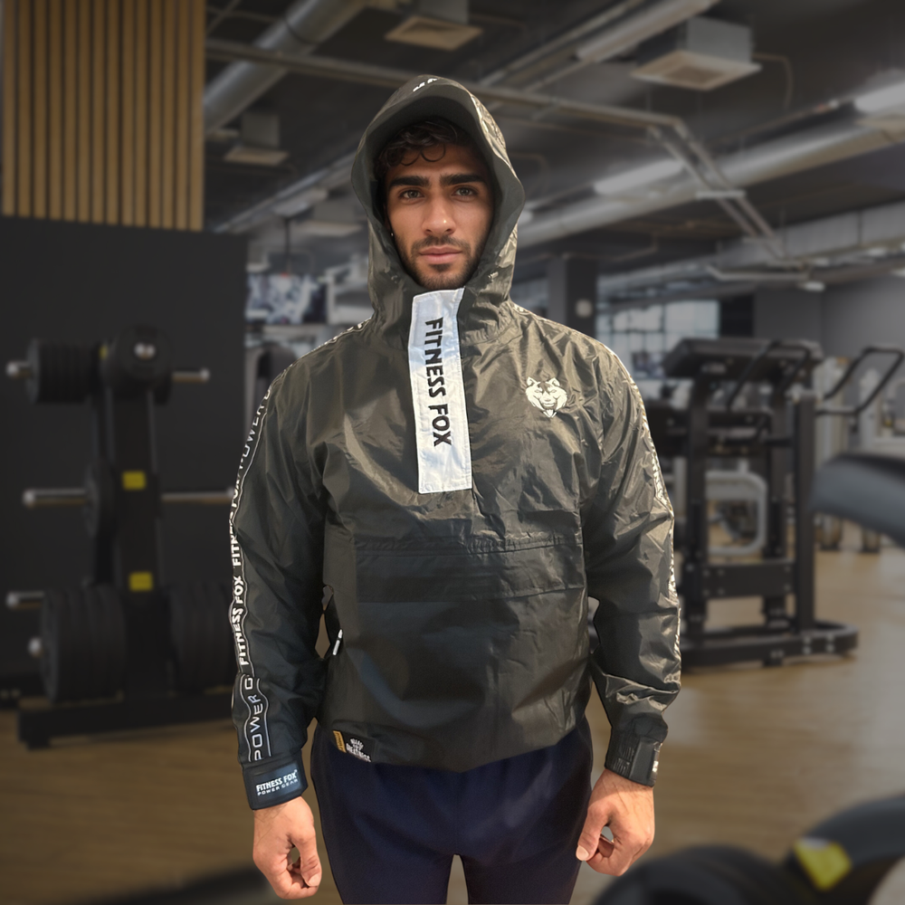 Side profile of the hooded sauna jacket showing anti-rip outer shell and adjustable wrist straps designed to retain heat while preserving comfortable mobility during workouts.