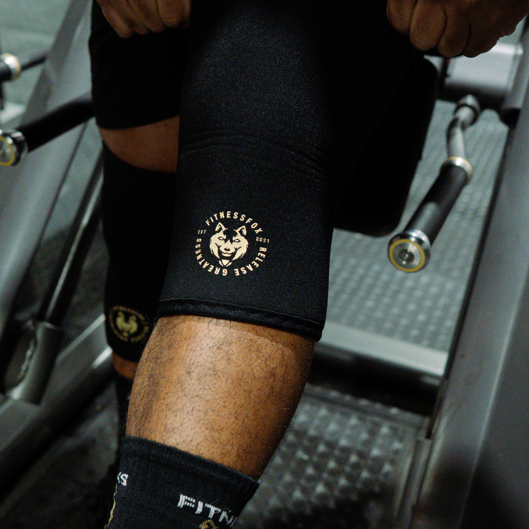 “Front view of Fitness Fox 7mm Pro knee sleeves showing reinforced stitching and supportive neoprene construction designed for steady squats and lunges.” 