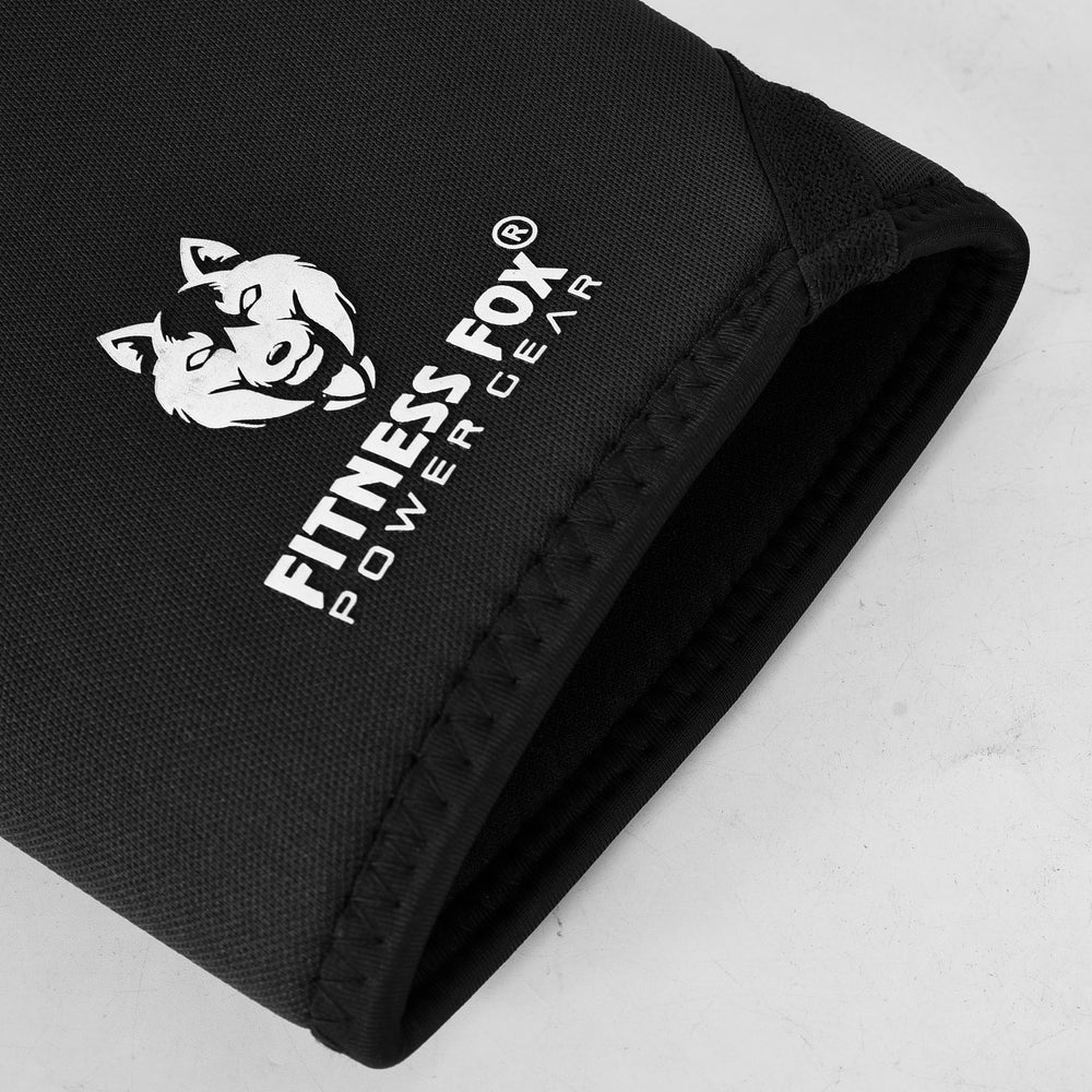 “Angled side profile of black 7mm knee sleeves highlighting anatomical shaping and anti-slip interior that helps the sleeves stay in place during training.”