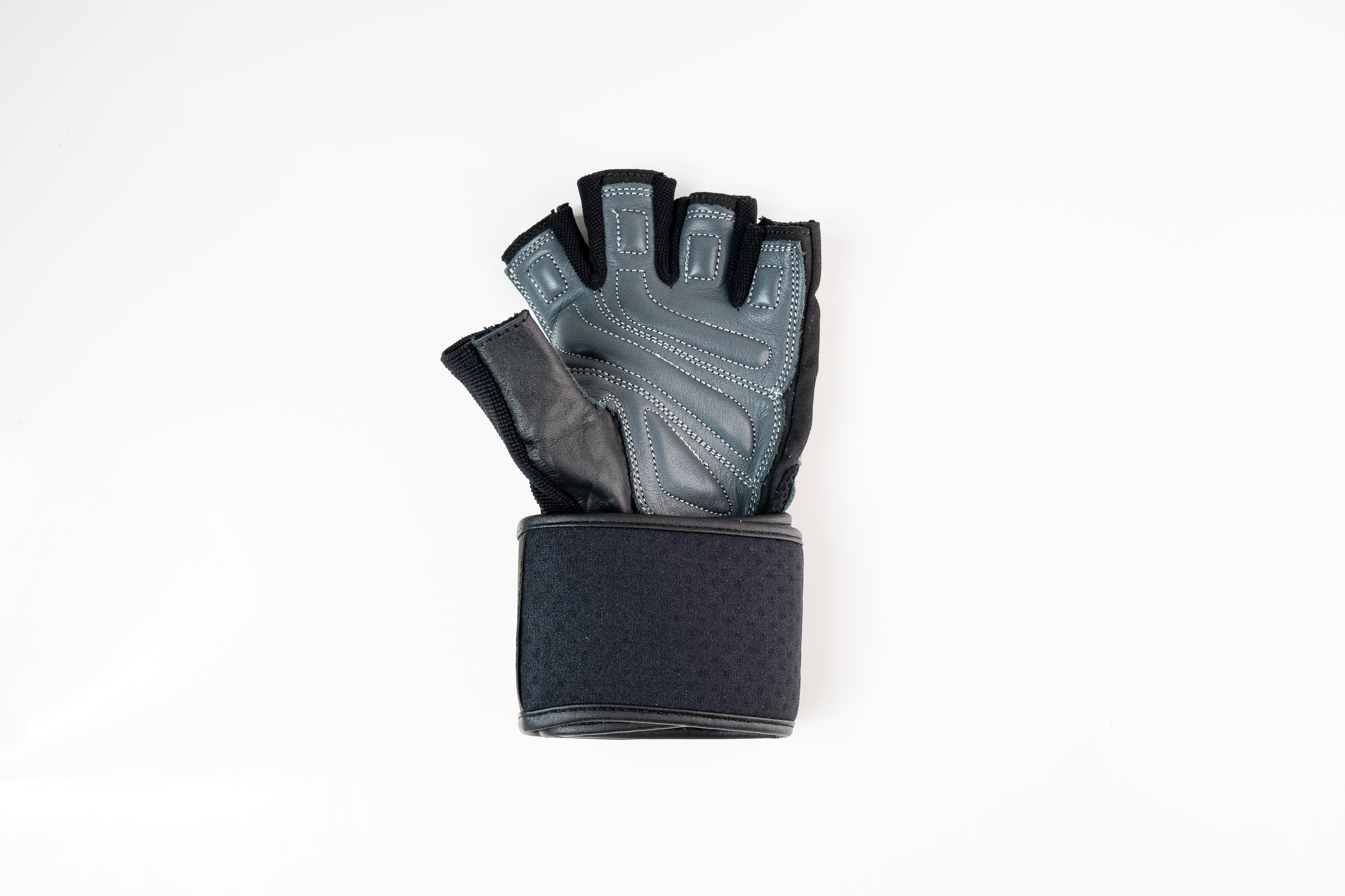 “Angled side profile of black and grey Fitness Fox gym gloves highlighting breathable polyester back panel with adjustable wrist strap for customizable tightness.”