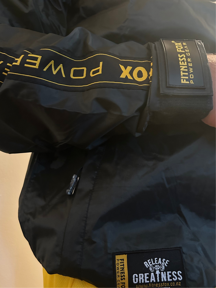 Back view of the Black Crewneck Sauna Jacket with Gold Strip, showcasing clean seams, elasticated ribs, and a streamlined silhouette for men and women.
