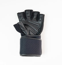 “Close-up of reinforced stitching and textured leather palm on Fitness Fox heavy-duty workout gloves engineered for durable control in strength sessions.”