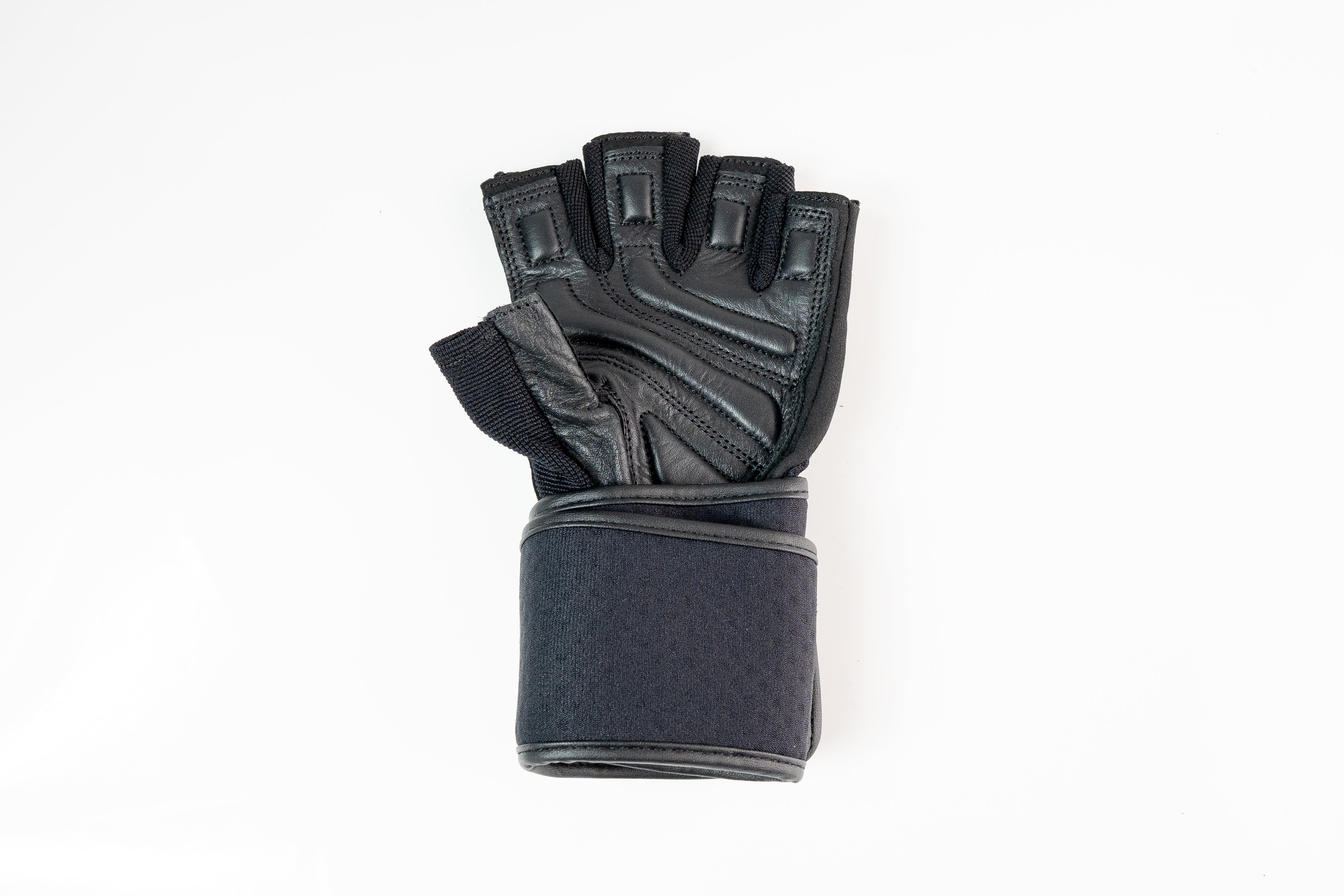 “Close-up of reinforced stitching and textured leather palm on Fitness Fox heavy-duty workout gloves engineered for durable control in strength sessions.”