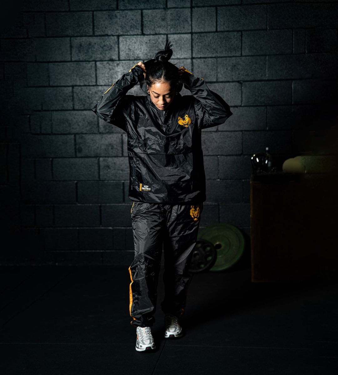 Front view of the Fitness Fox half-zip hooded sauna jacket in black, highlighting the rubberised lining and streamlined athletic fit for heat-focused training sessions. 